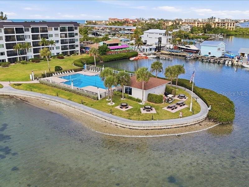 8911 Midnight Pass Road, Unit 208 Sarasota, FL 34242 - Photo 35 of 46 a view of a swimming pool with outdoor seating