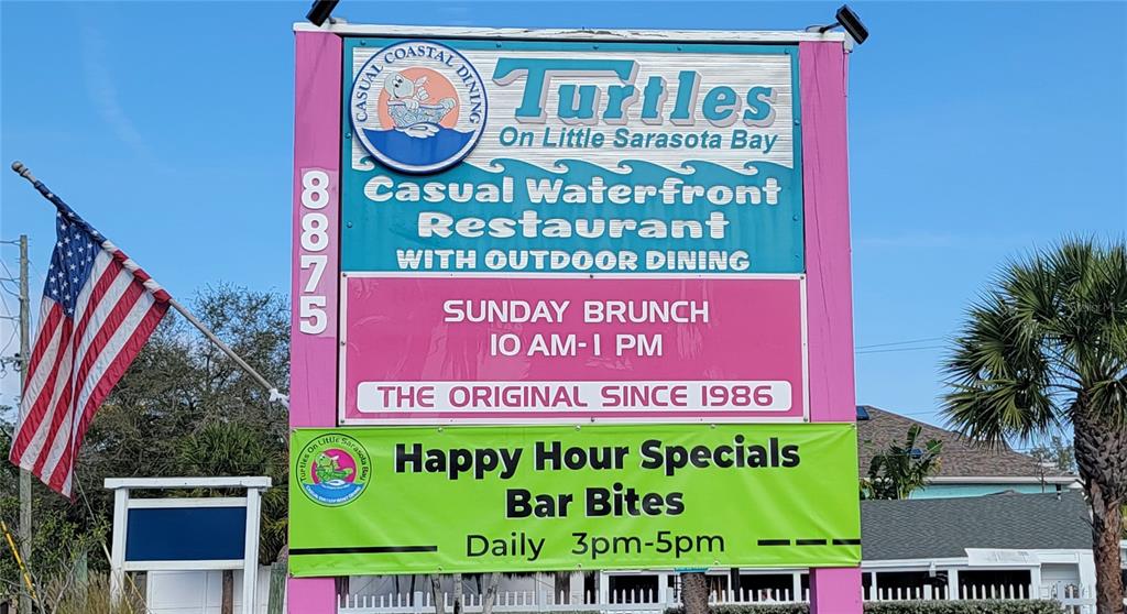 8911 Midnight Pass Road, Unit 208 Sarasota, FL 34242 - Photo 45 of 46 a sign on the wall of a building