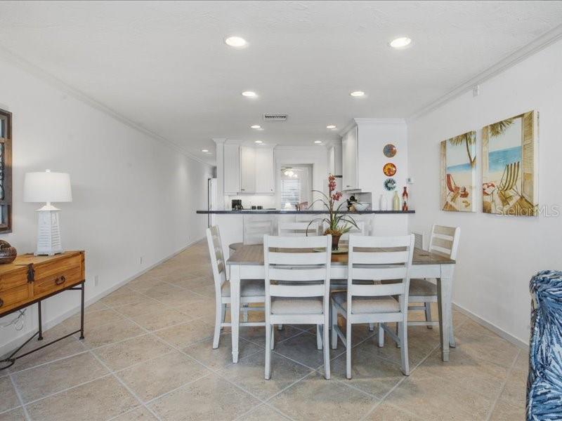 8911 Midnight Pass Road, Unit 208 Sarasota, FL 34242 - Photo 9 of 46 a dining area with a table and chairs in it