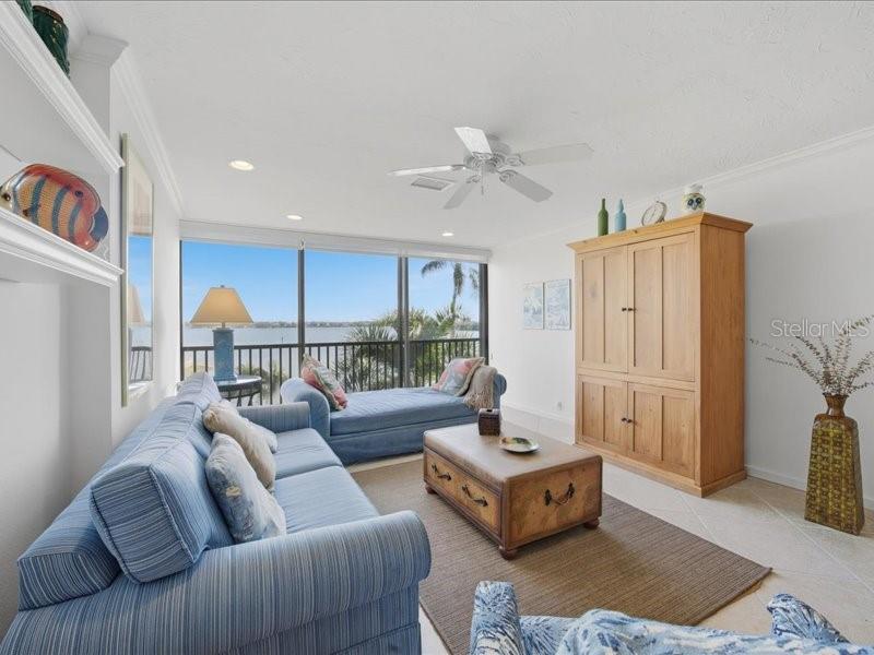 8911 Midnight Pass Road, Unit 208 Sarasota, FL 34242 - Photo 10 of 46 a living room with furniture and a window