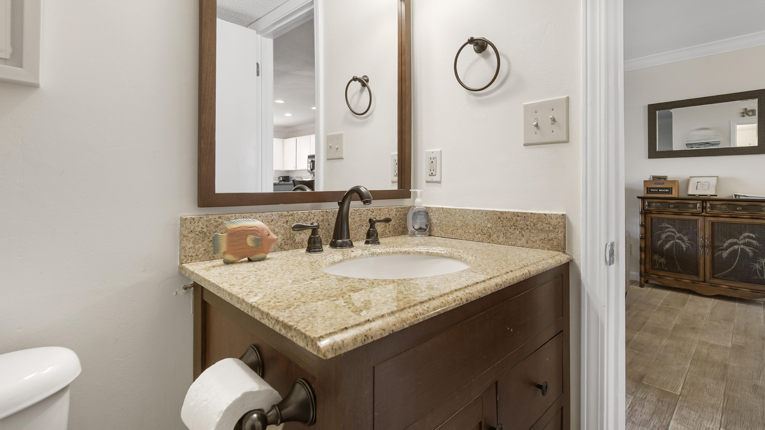 25 Misty Cove, Unit 116 Miramar Beach, FL 32550 - Photo 13 of 52 a bathroom with a granite countertop sink a toilet and a mirror