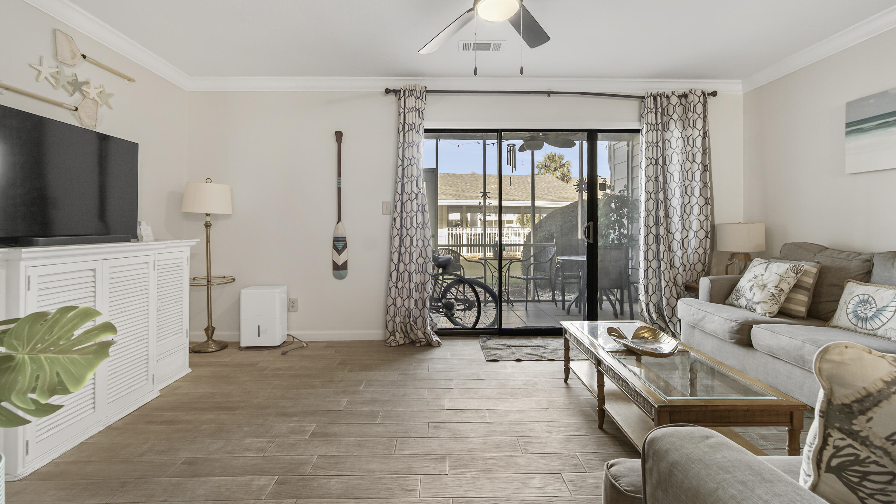 25 Misty Cove, Unit 116 Miramar Beach, FL 32550 - Photo 14 of 52 a living room with furniture and a flat screen tv