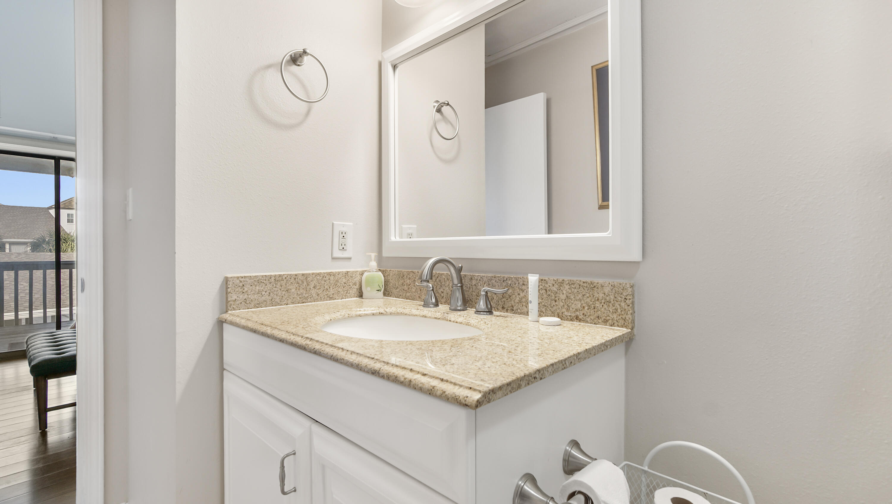 25 Misty Cove, Unit 116 Miramar Beach, FL 32550 - Photo 29 of 52 a bathroom with a granite countertop sink and a mirror