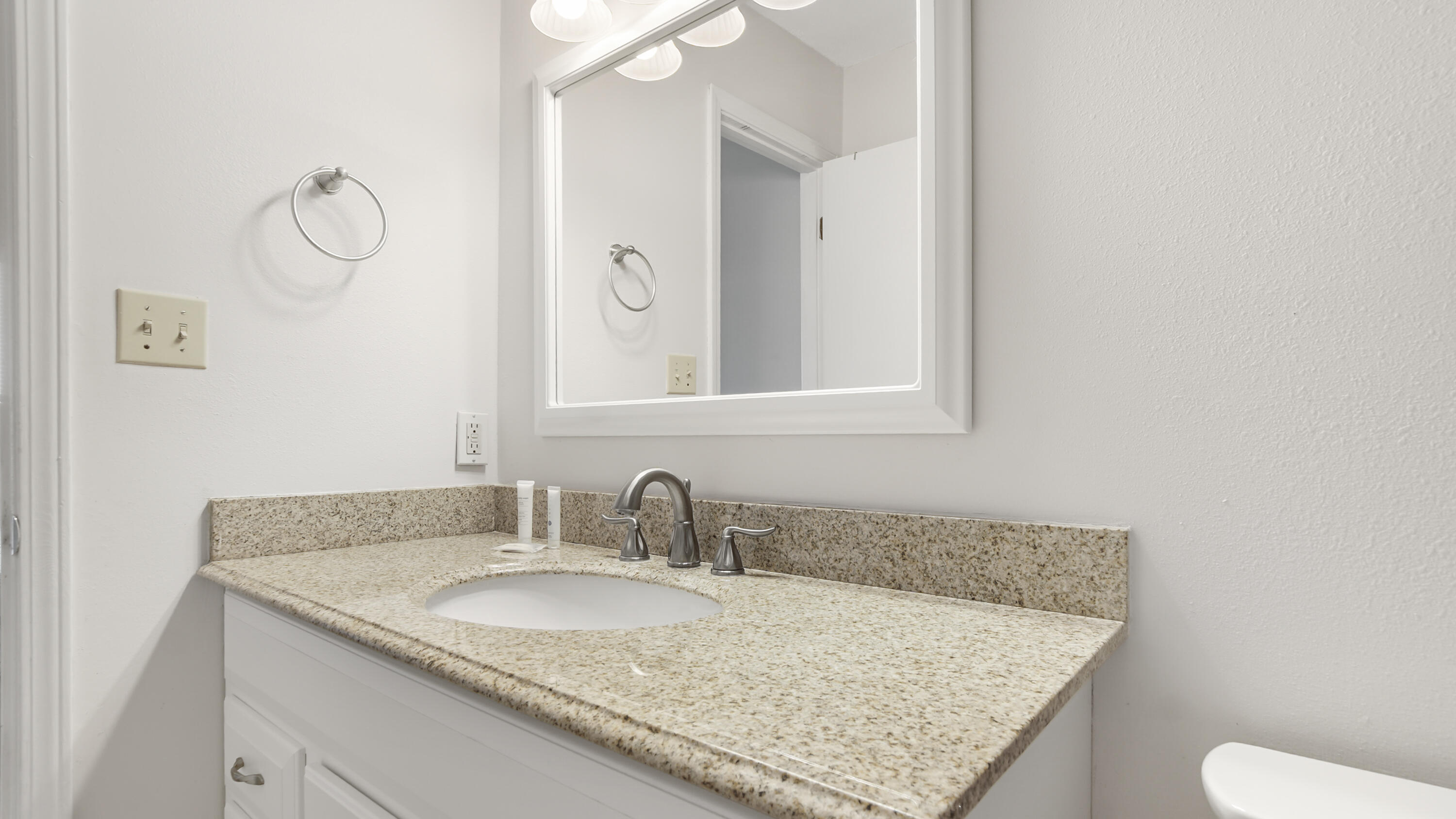25 Misty Cove, Unit 116 Miramar Beach, FL 32550 - Photo 41 of 52 a bathroom with a granite countertop sink and a mirror