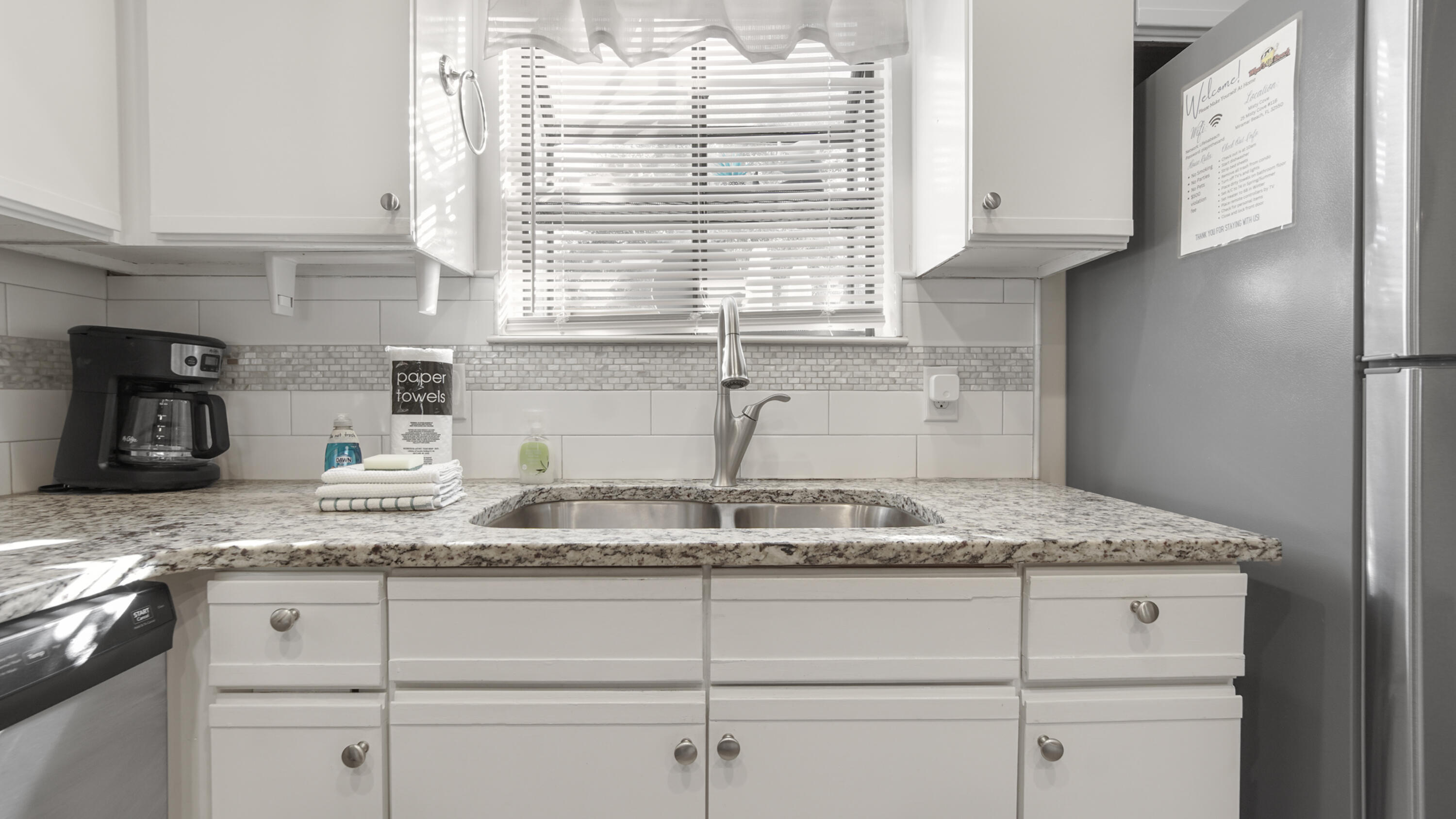 25 Misty Cove, Unit 116 Miramar Beach, FL 32550 - Photo 7 of 52 a kitchen with granite countertop cabinets and window