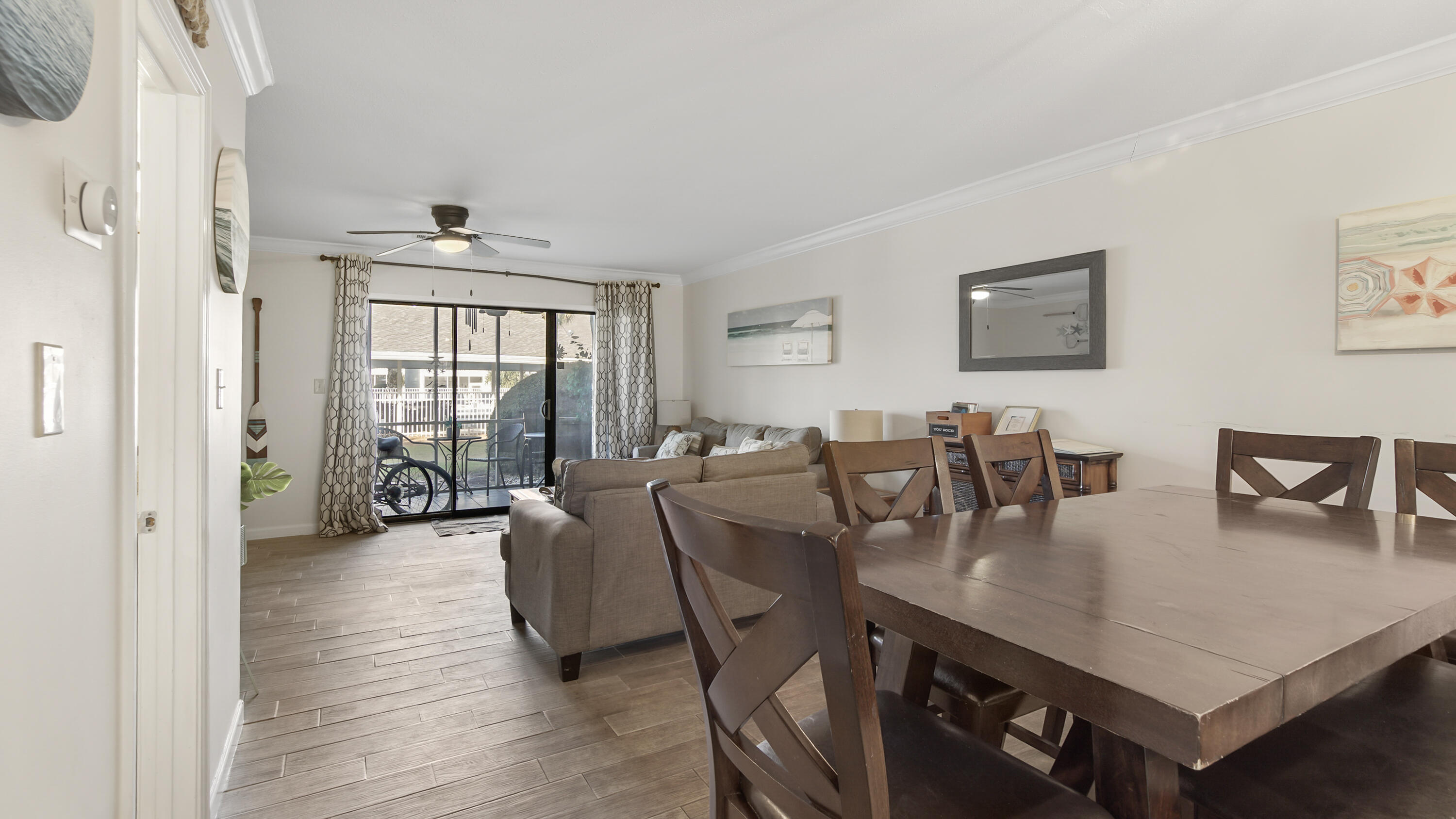 25 Misty Cove, Unit 116 Miramar Beach, FL 32550 - Photo 10 of 52 a living room with furniture a large window and dining table