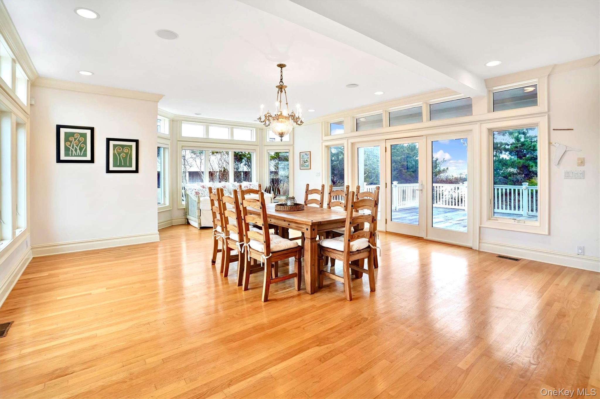 605 Dune Road Westhampton, NY 11978 - Photo 13 of 44 Huge Dining area with healthy amount of natural light, light wood-type flooring, a chandelier, and recessed lighting. Doors out to very large deck.