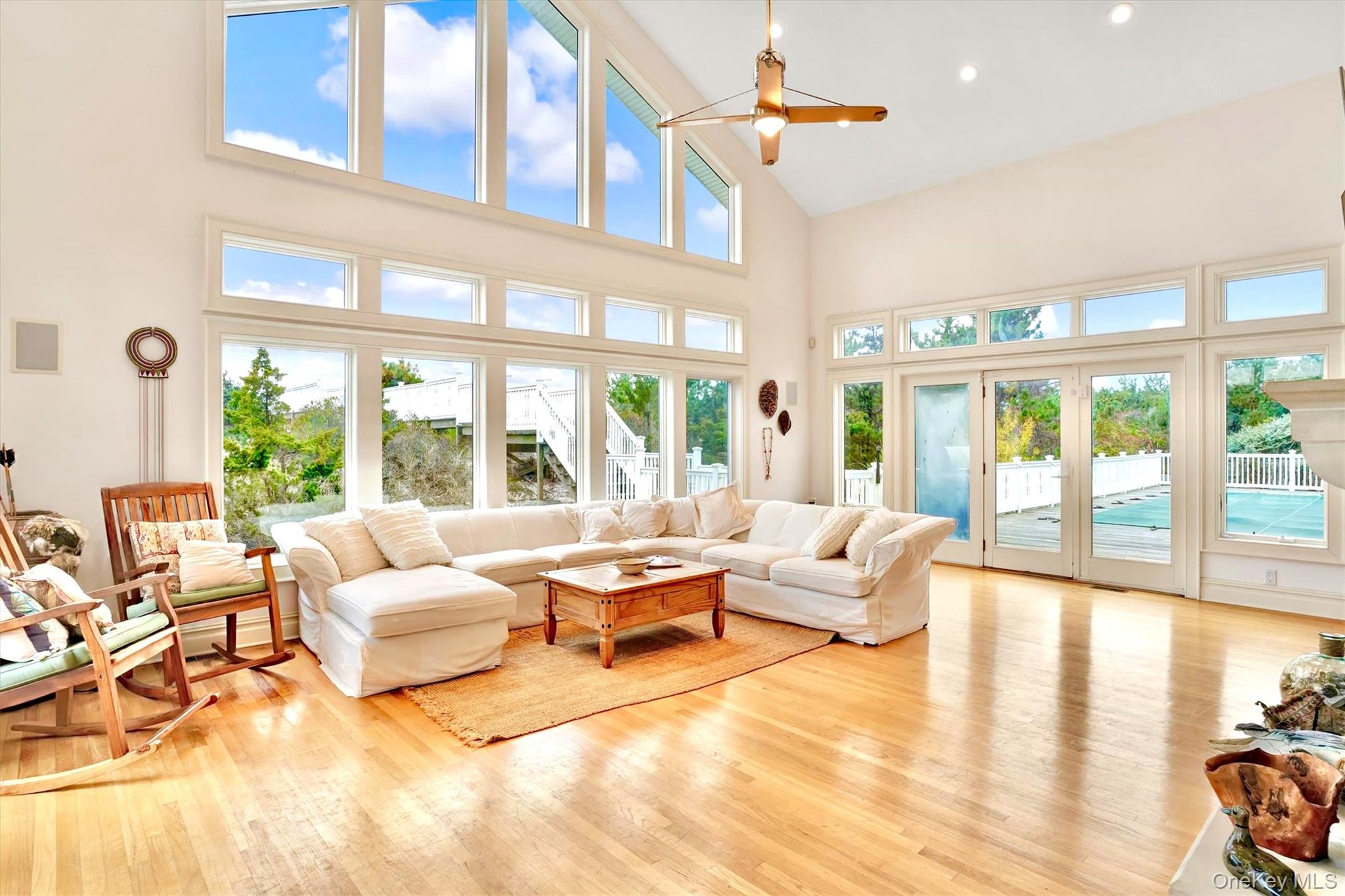 605 Dune Road Westhampton, NY 11978 - Photo 14 of 44 Living room featuring high vaulted ceiling, light wood-style floors, a ceiling fan, and recessed lighting