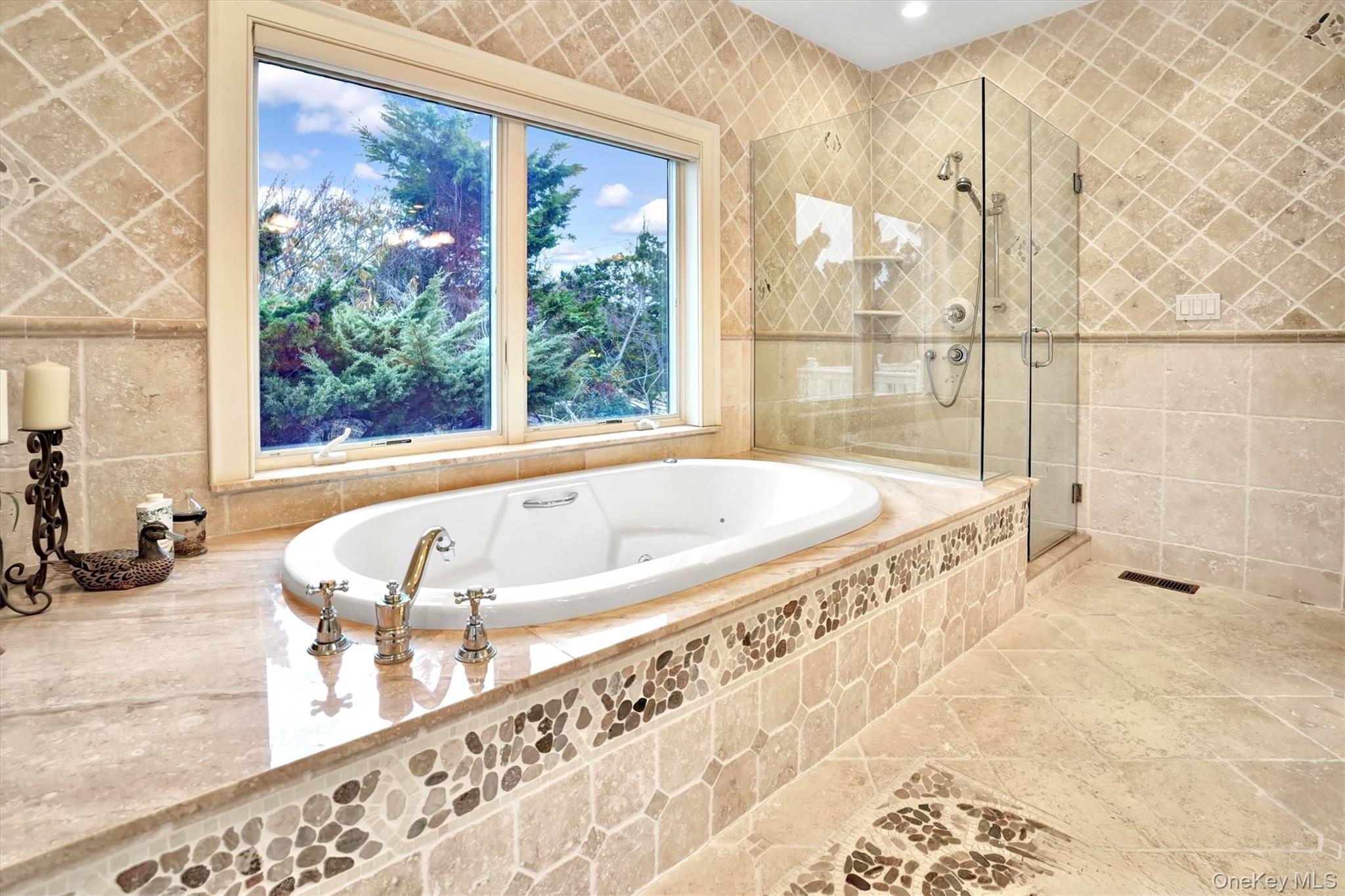 605 Dune Road Westhampton, NY 11978 - Photo 19 of 44 First Floor en-suite Deluxe Primary Bathroom for first floor Primary with tile walls, a jetted tub, a stall shower, and tile patterned flooring