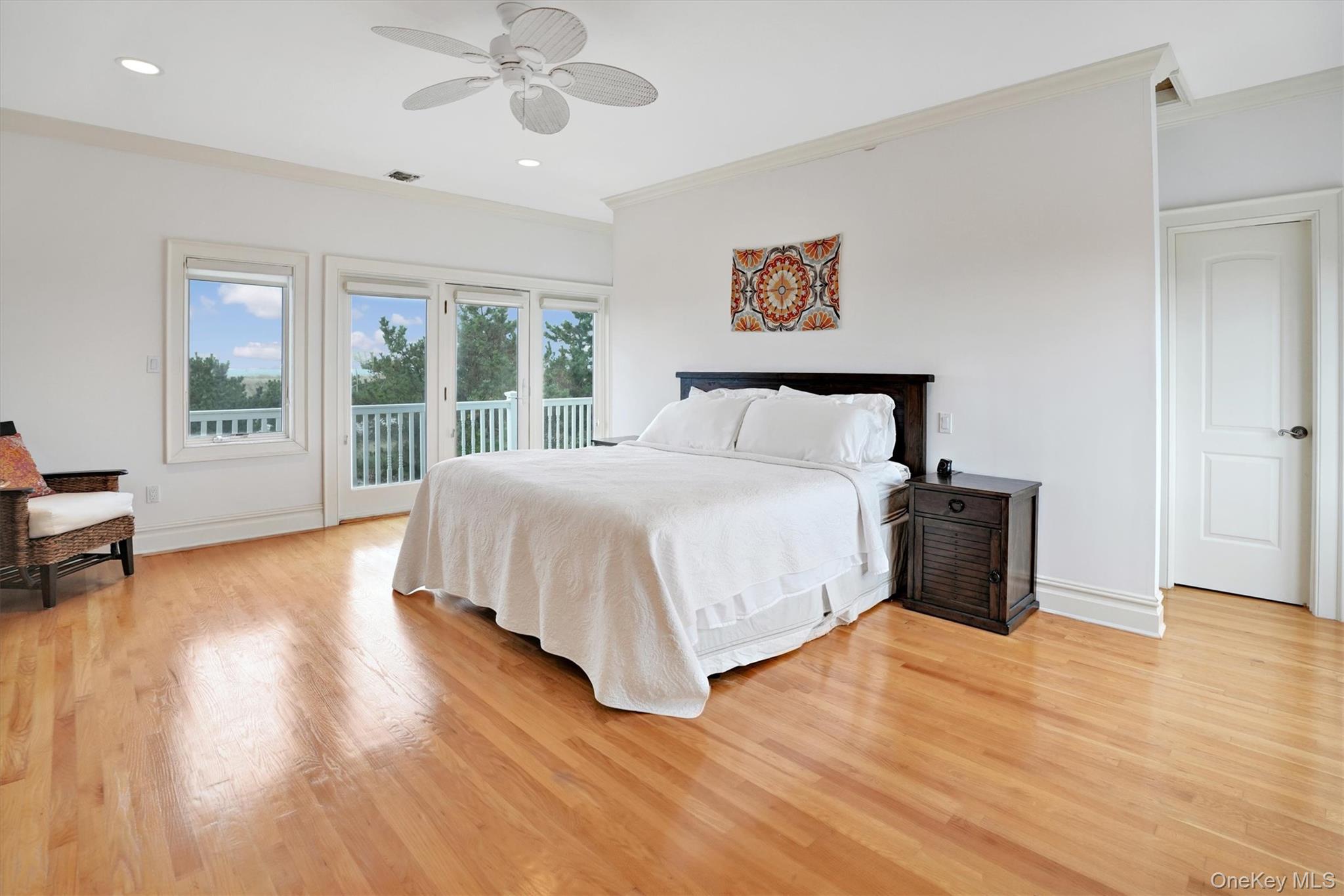 605 Dune Road Westhampton, NY 11978 - Photo 23 of 44 Second Floor Primary Bedroom featuring access to exterior, crown molding, light wood finished floors, ceiling fan, and recessed lighting