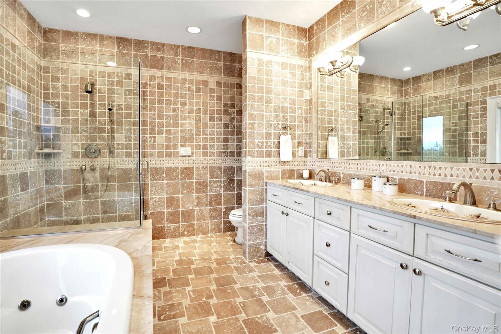 605 Dune Road Westhampton, NY 11978 - Photo 27 of 44 Second Floor Primary Bathroom en-suite featuring tile walls, double vanity, recessed lighting, a whirlpool tub, and a tile shower
