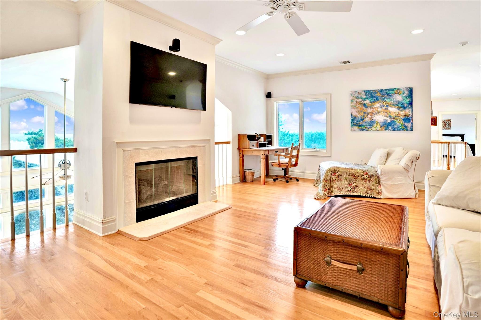 605 Dune Road Westhampton, NY 11978 - Photo 31 of 44 Living area featuring an office area, ornamental molding, light wood-style flooring, a glass covered fireplace, and recessed lighting