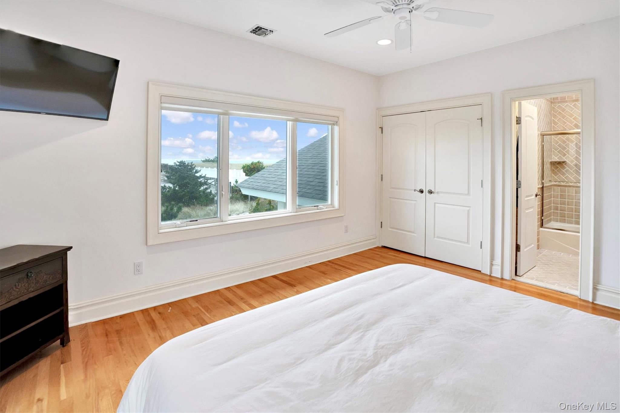 605 Dune Road Westhampton, NY 11978 - Photo 33 of 44 Third Oceanfront Bedroom featuring light wood-type flooring, ceiling fan, ensuite bathroom, recessed lighting, and a closet