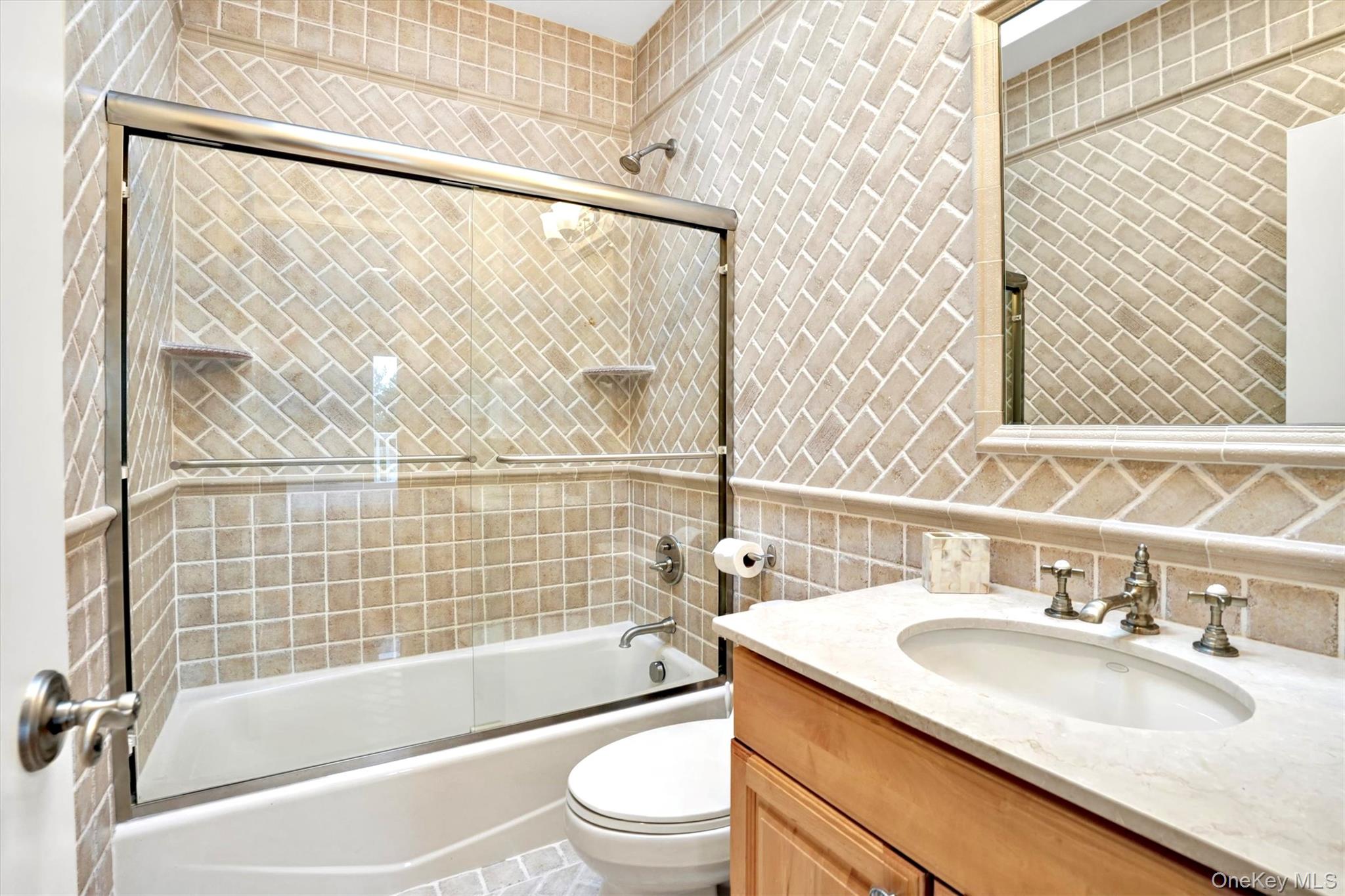 605 Dune Road Westhampton, NY 11978 - Photo 34 of 44 Third Oceanfront Bedroom en-suite bathroom. Full bath with tile walls, vanity, shower / bath combination with glass door, and tasteful backsplash