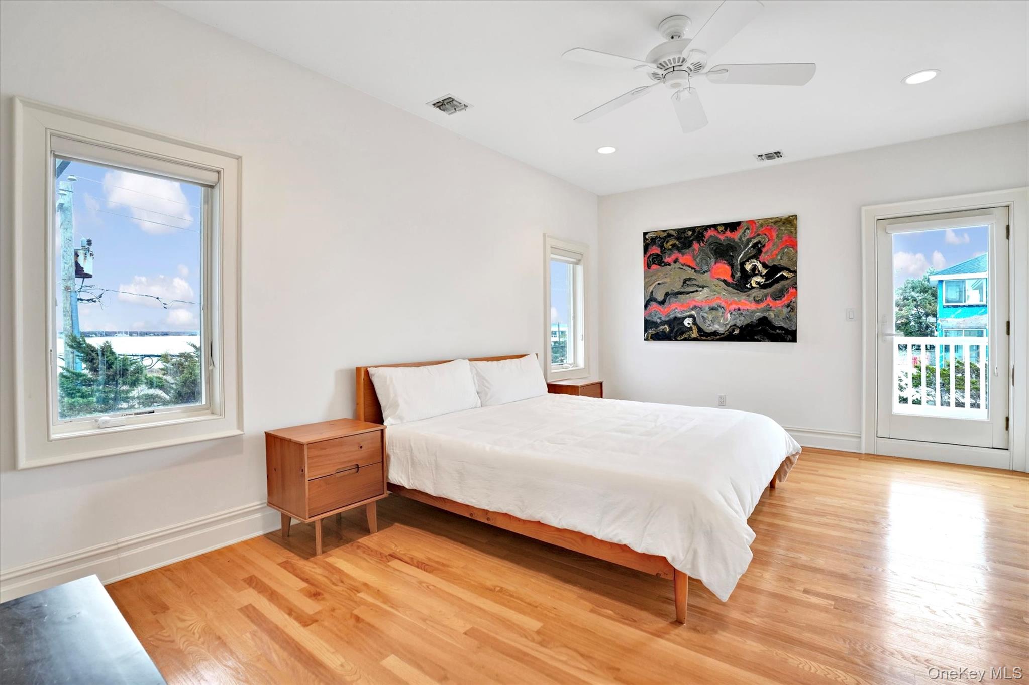605 Dune Road Westhampton, NY 11978 - Photo 35 of 44 4th Bedroom with Bay and door to sitting deck for Ocean & Bay views, featuring access to outside, light wood-type flooring, a ceiling fan, and recessed lighting