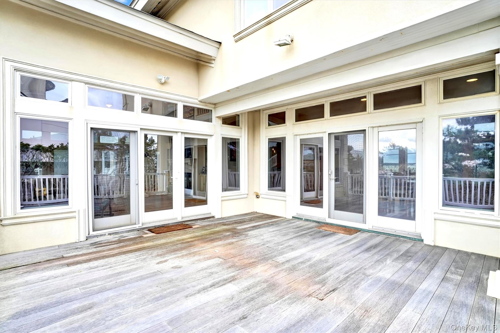 605 Dune Road Westhampton, NY 11978 - Photo 39 of 44 Double french doors from Dining Room and Living Room to Deck for Entertaining.