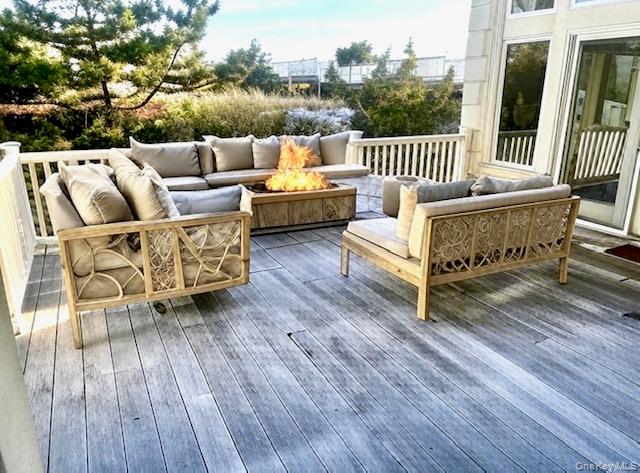 605 Dune Road Westhampton, NY 11978 - Photo 41 of 44 Ai Added furniture. Wooden terrace with an outdoor living space with a fire pit
