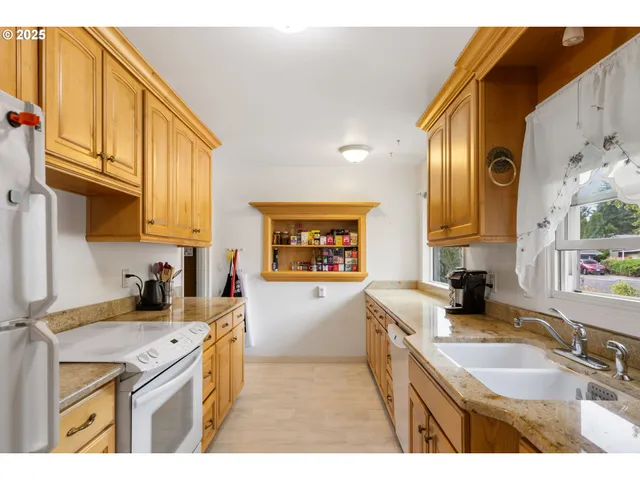 a kitchen with a sink stove and refrigerator