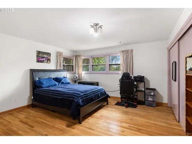 a living room with a bed furniture and a window