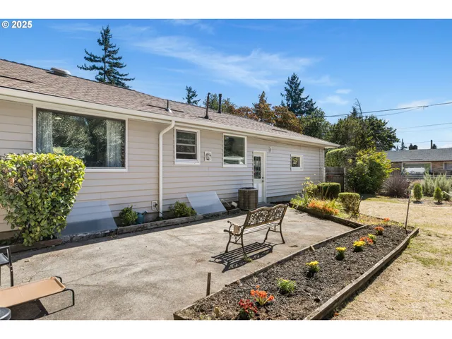 a view of a patio with couches table and chairs with potted plants