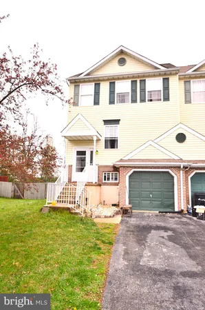 a front view of a house with a garden and yard