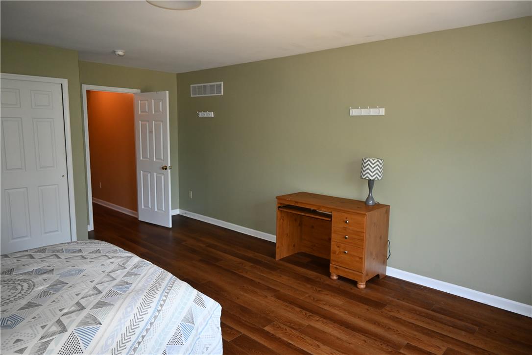 3829 East Hopewell Road Center Valley, PA 18034 - Photo 42 of 52 Rich hardwood-style flooring extends through this tranquil sleeping space, featuring a convenient closet and an inviting entry.