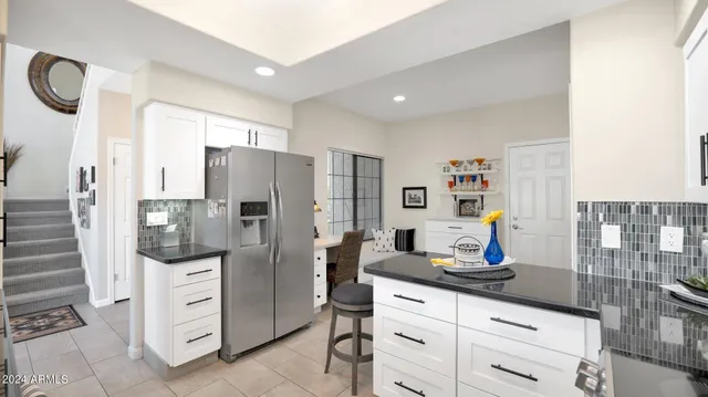 a kitchen with refrigerator and cabinets