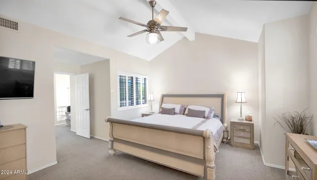 a bed room with a bed and a television