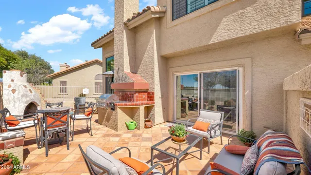 a view of a patio with dining table and chairs with wooden floor and fence