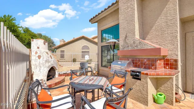a view of a patio with table and chairs and potted plants
