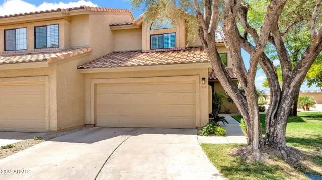 a view of a house with a tree