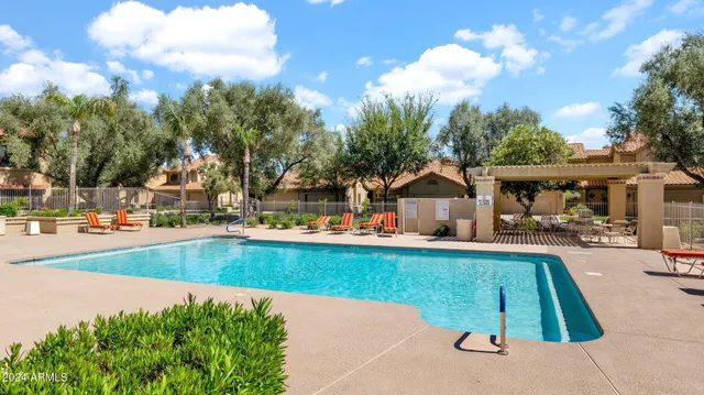 swimming pool view with a outdoor seating