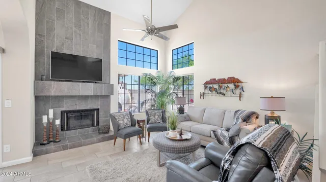 a living room with furniture a fireplace and a flat screen tv