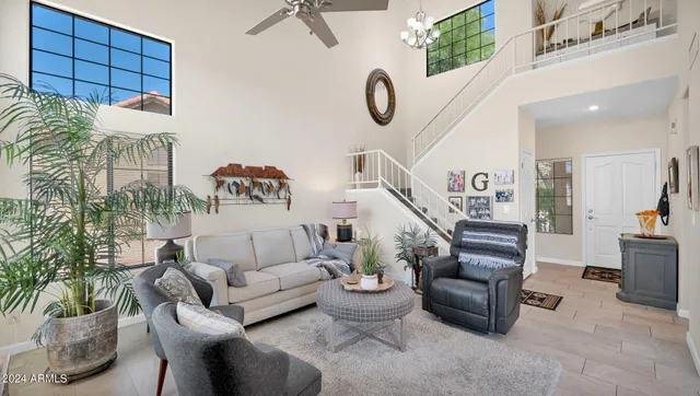 a living room with furniture and a potted plant