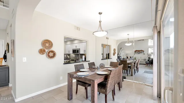 a dining room with furniture and wooden floor