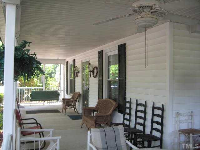 Wrap around covered country porch, large enough for lots of furniture, and of course the swing.