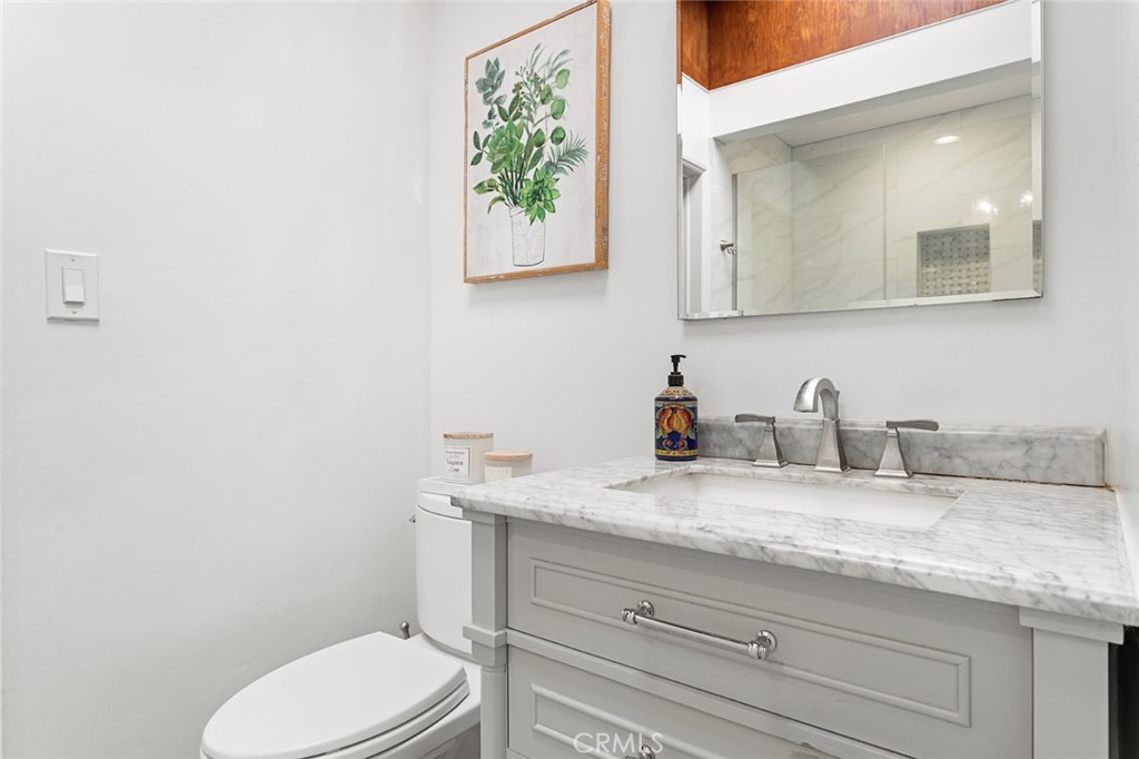1626 Rodeo Road Arcadia, CA 91006 - Photo 16 of 28 a bathroom with a granite countertop toilet sink and mirror