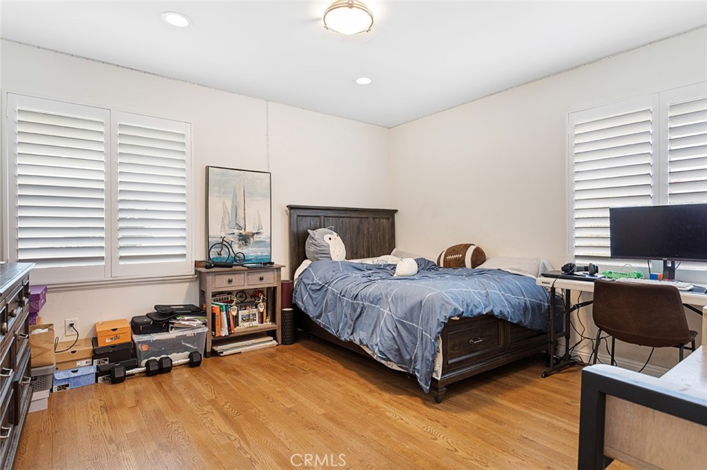 1626 Rodeo Road Arcadia, CA 91006 - Photo 18 of 28 a spacious bedroom with a bed a couch and a flat screen tv