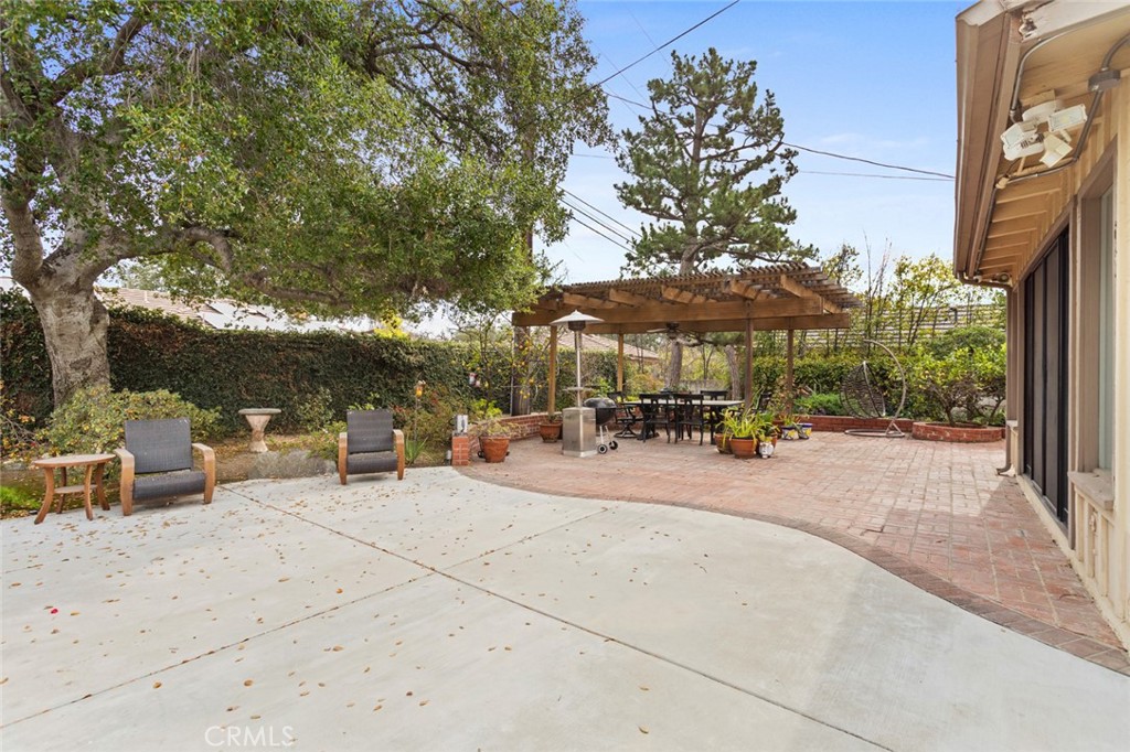 1626 Rodeo Road Arcadia, CA 91006 - Photo 25 of 28 a patio with a table and chairs under an umbrella