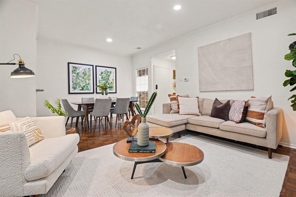 14277 Preston Road, Unit 315 Dallas, TX 75254 - Photo 9 of 20 Cozy living room with fireplace, open layout, kitchen views, and patio access for easy entertaining.
