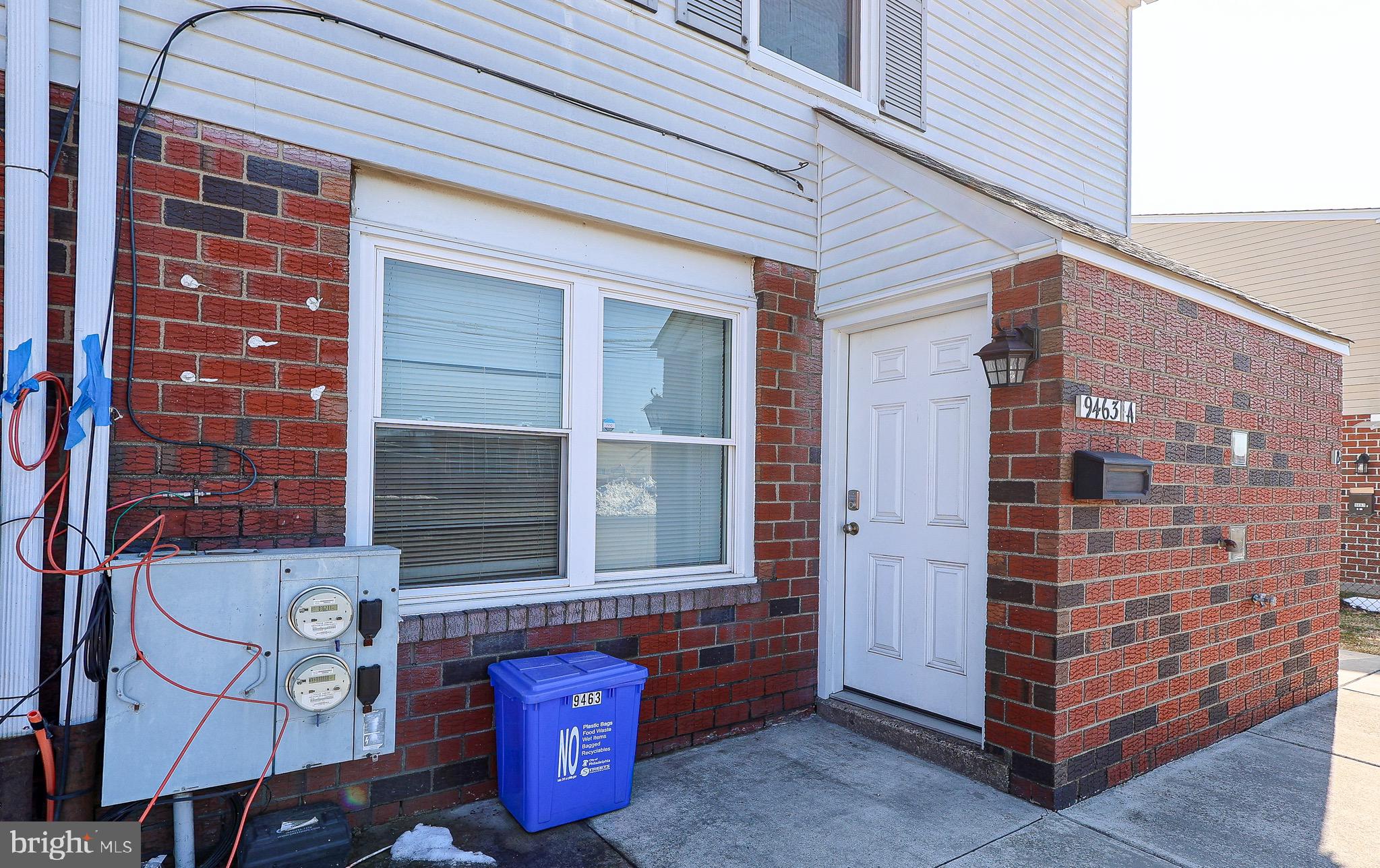 9463 Ashton Road, Unit 1 Philadelphia, PA 19114 - Photo 2 of 25 a front view of a building with a glass door