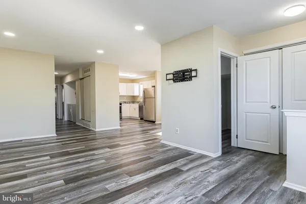 a view of a hallway with wooden floor