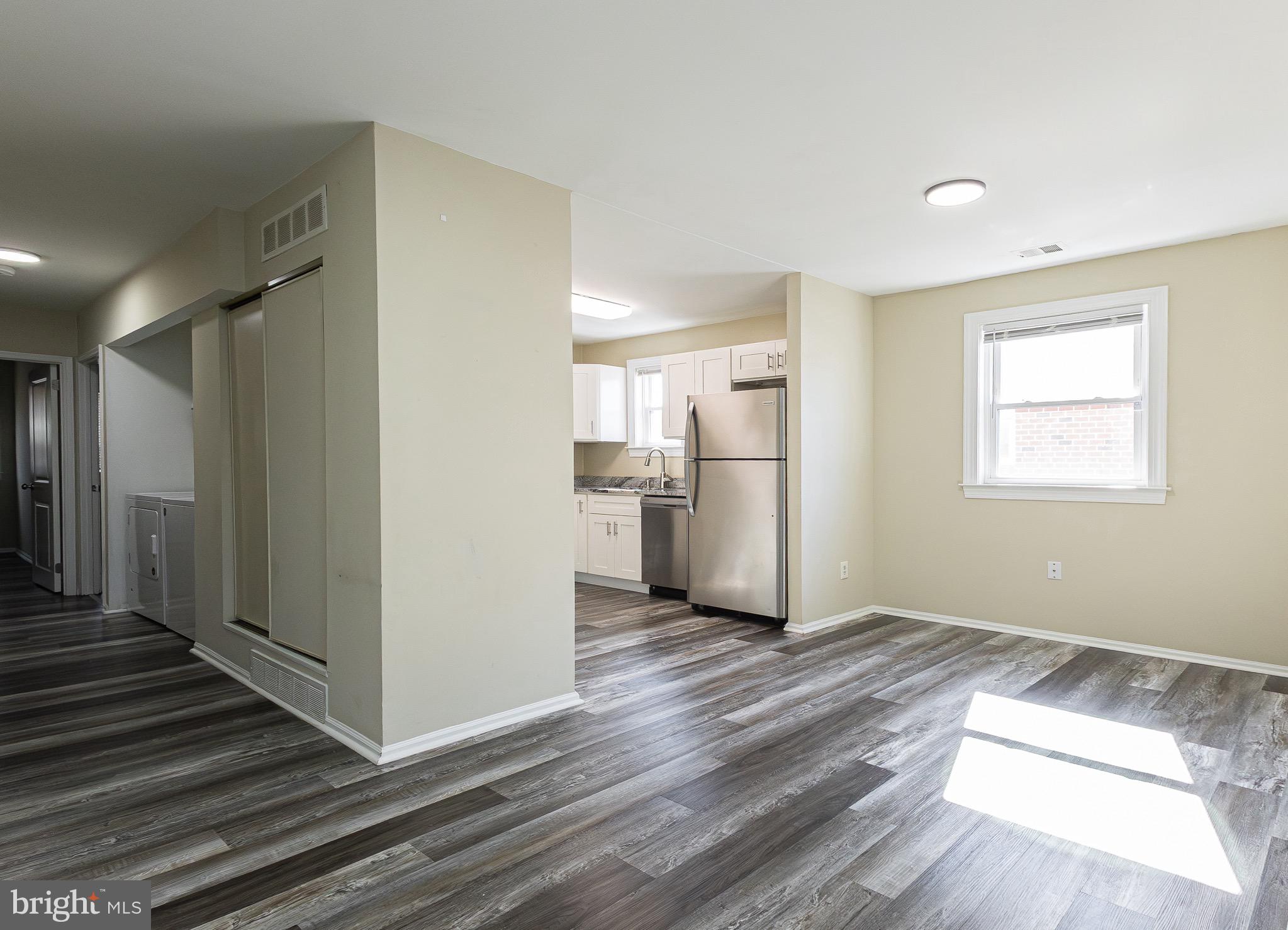 9463 Ashton Road, Unit 1 Philadelphia, PA 19114 - Photo 7 of 25 a view of a kitchen with wooden floor and a hallway