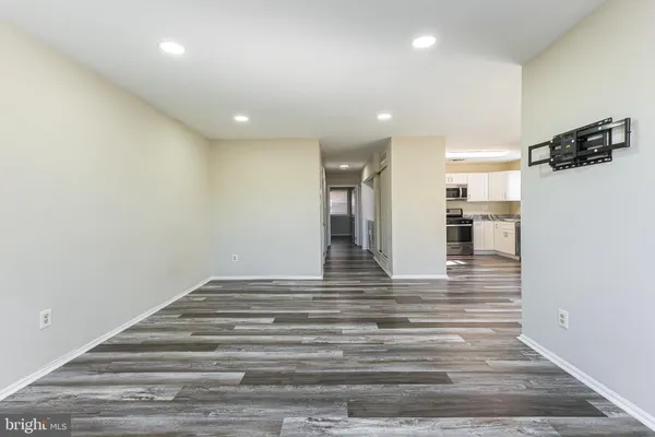 a view of a hallway with wooden floor