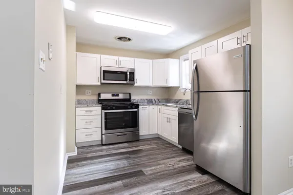 a kitchen with a refrigerator a stove top oven a refrigerator and a window