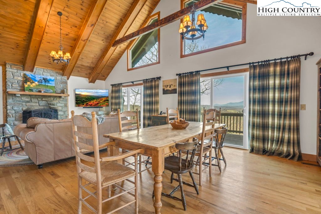 198 Laurel Hill Lane Boone, NC 28607 - Photo 14 of 50 a dining room with furniture wooden floor and a potted plant