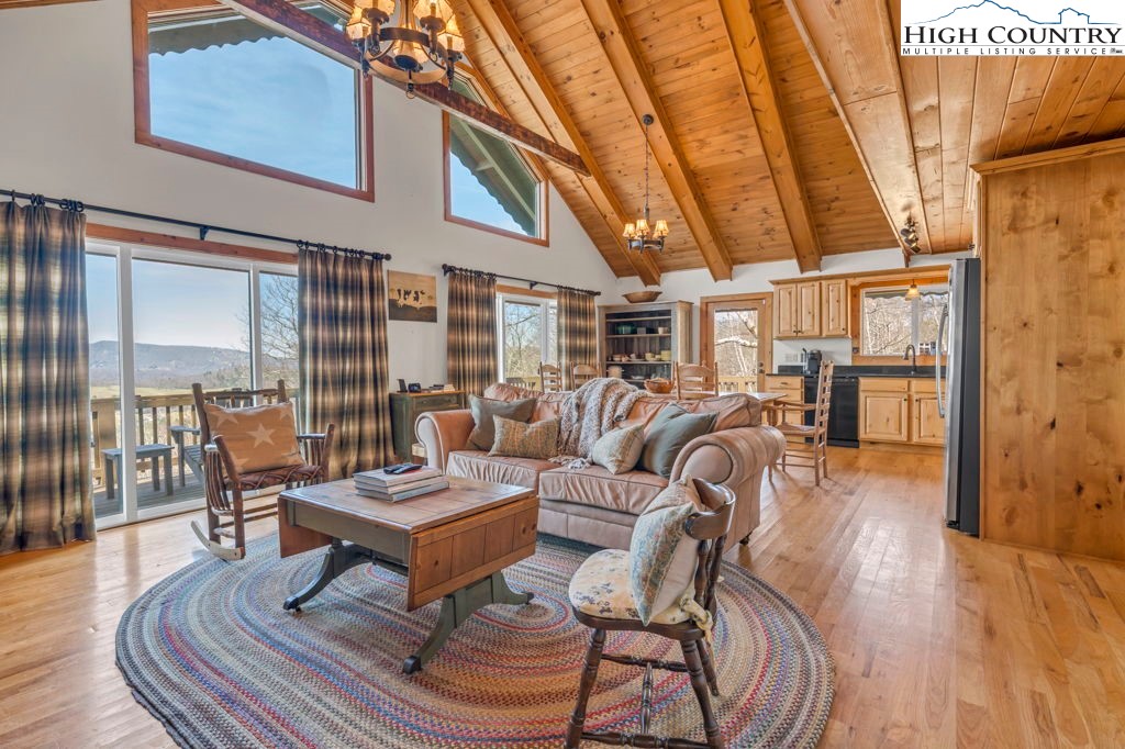 198 Laurel Hill Lane Boone, NC 28607 - Photo 20 of 50 a living room with furniture a wooden floor and next to a window