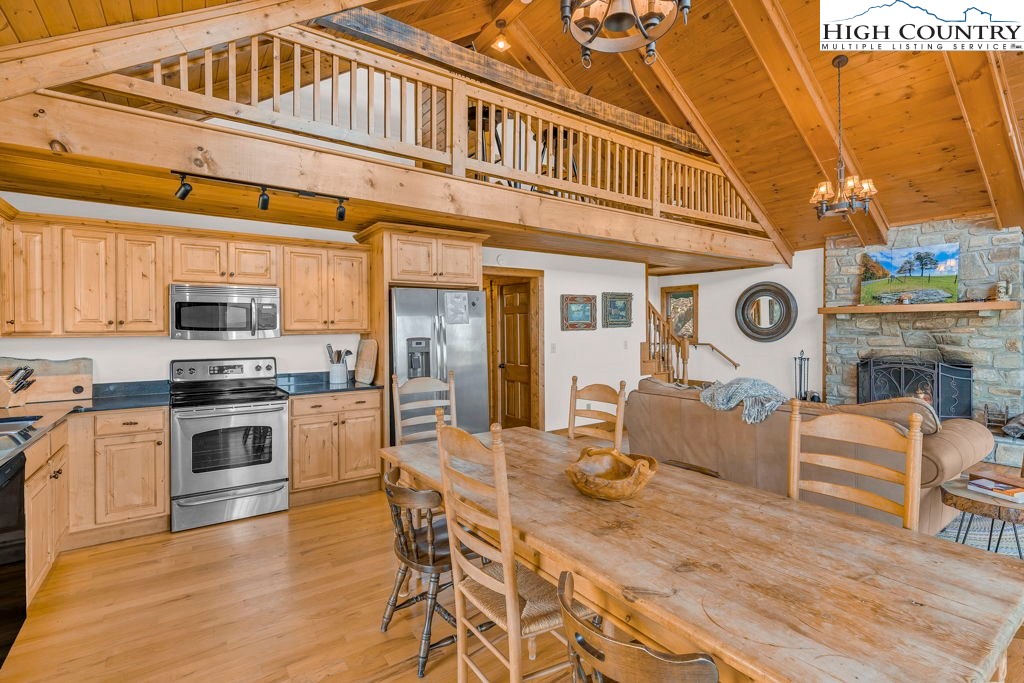 198 Laurel Hill Lane Boone, NC 28607 - Photo 22 of 50 a kitchen with stainless steel appliances granite countertop a stove and white cabinets