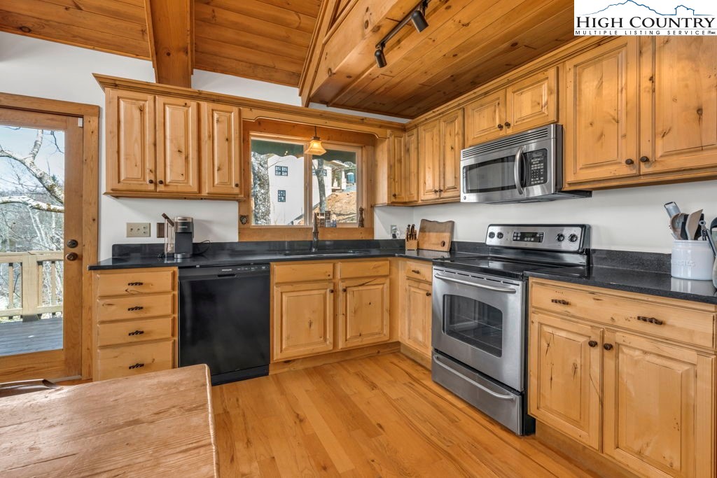 198 Laurel Hill Lane Boone, NC 28607 - Photo 23 of 50 a kitchen with stainless steel appliances granite countertop a stove a sink and a microwave
