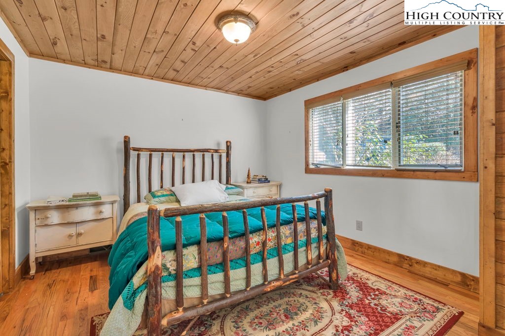 198 Laurel Hill Lane Boone, NC 28607 - Photo 27 of 50 a bedroom with furniture and a window